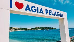a sign for a beach in asia pelica at Michele Marie apts in Agia Pelagia