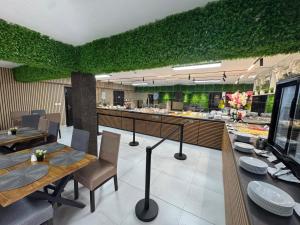 a restaurant with tables and chairs and a green wall at Chalet 173 in Gura Humorului
