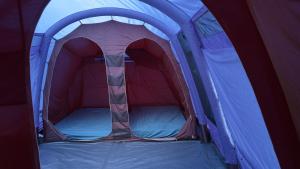 a blue and red tent with the door open at Glen Wyllin Campsite in Kirkmichael
