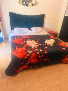 a bed with a black comforter with skulls on it at B&Bapartment in Arta