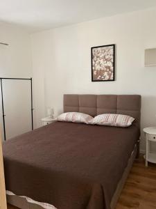 a bedroom with a large bed in a room at Apartment K&M in Bibinje