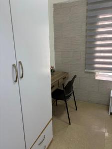 a room with a desk and a chair and a window at Laila's studio in Haifa