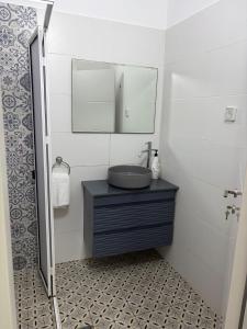 a bathroom with a sink and a mirror at Laila's studio in Haifa +3 photos
