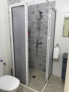 a shower stall in a bathroom with a toilet at Laila's studio in Haifa
