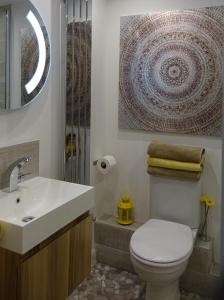 a bathroom with a white toilet and a sink at City Centre Haven Apartments in Edinburgh