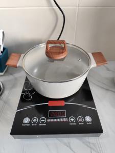 a pot on top of a scale on a counter at HeyFam Homestay in Sekinchan +12 photos