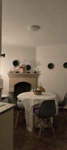 a dining room with a table with chairs and a fireplace at Plantier Guesthouse in Figueira de Castelo Rodrigo +4 photos