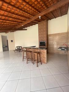 a kitchen with wooden tables and chairs in a room at Pousada Brilho dos Lençóis in Barreirinhas