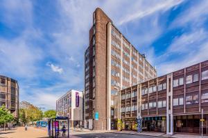 a tall brick building on a city street at Stylish Flat in the City Centre - Pass the Keys in Portsmouth