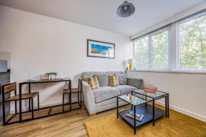 a living room with a couch and two tables at Stylish Flat in the City Centre - Pass the Keys in Portsmouth