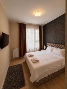 a bedroom with a large white bed and a window at Aria Lux Belgrade Waterfront in Belgrade