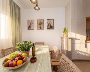 a dining room table with a bowl of fruit on it at Villa Aurea Luxury Sunset with Pool in Krimovice