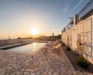 a pool on the side of a building with the sunset at Villa Aurea Luxury Sunset with Pool in Krimovice