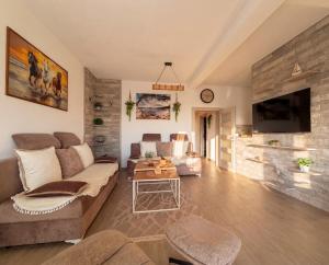 a living room with a couch and a table at Villa Aurea Luxury Sunset with Pool in Krimovice