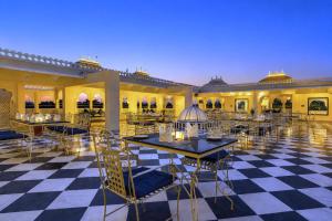 a restaurant with tables and chairs on a checkered floor at The Amar Mahal Luxury Heritage Hotel Near Fateh Sagar Lake, Udaipur in Udaipur