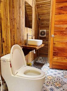 a bathroom with a toilet and a sink at Waikiki Lagi Beach in Ấp Tam Tân +37 photos