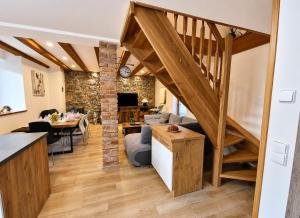 a living room with a staircase and a living room with a couch at Podbrdská chalupa in Nechanice
