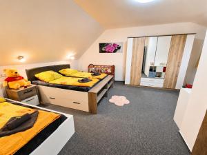 a bedroom with two beds and a teddy bear in it at Podbrdská chalupa in Nechanice +72 photos