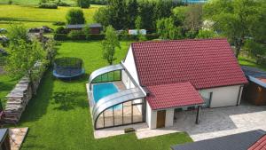 a small house with a red roof and a swimming pool at Podbrdská chalupa in Nechanice