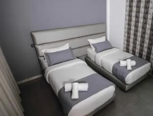 two beds in a room with crosses on them at ALYA SAPHIR in Saïdia +5 photos