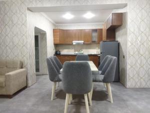 a kitchen with a table and chairs and a couch at TamoLand in Astara