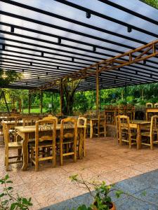 a group of tables and chairs under a pavilion at Campo Eden in Capitán Miranda +2 photos