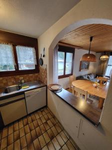 a kitchen with a table and a dining room at Wohnung Casa Hirundella in Trin