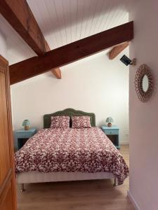 a bedroom with a bed and two end tables at Maisonnette près du lac in Léon