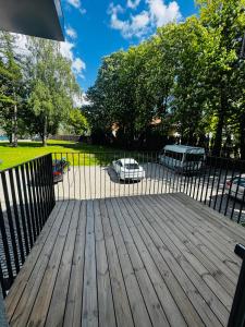 a wooden deck with a fence in a yard at Apartment in the city center near park and river 5 in Marijampolė