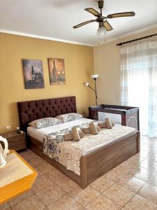 a bedroom with a bed and a ceiling fan at Theodora’s Studios 2 in Repanídhion