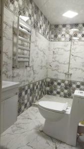 a white bathroom with a toilet and a sink at TamoLand in Astara +15 photos