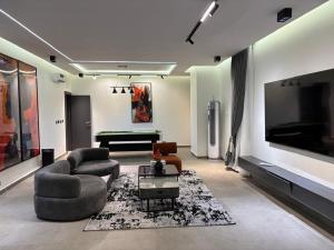 a living room with a couch and a pool table at Reign Residence in Port Harcourt