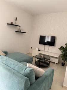 a living room with a couch and a tv at Apartment K&M in Bibinje