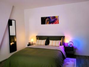 a bedroom with a bed and a painting on the wall at Chez Toi Ailleurs - Dinant in Dinant