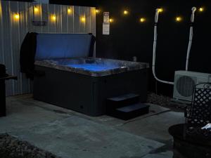 a hot tub in a dark room with lights at Sunset in Hillsboro