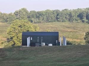 a black building sitting on top of a field at Sunset in Hillsboro +6 photos