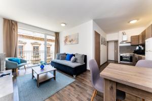 a living room with a couch and a table at Nova City Apartments in Budapest