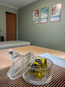 a glass bowl with a bag of chips on a table at Sol e Sal Suítes Aconchegantes in Saquarema