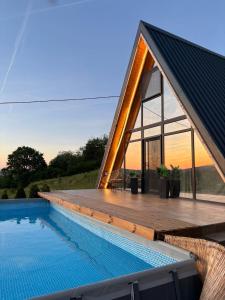 a house with a swimming pool and a deck at Vila Ahouse in Jagodina