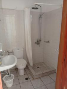 a bathroom with a toilet and a shower and a sink at Gikas Apartments Triple Studio Garden View A2 in Marmari +25 photos