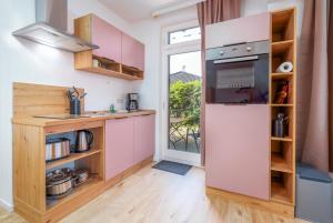 a kitchen with a refrigerator and a window at Meeresbrise in Thiessow