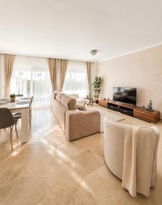 a large living room with a couch and a television at Spacious Apartment with Garden & Terrace in Puerto de Santiago