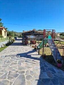 a playground with a slide at Κτήμα Καρνέση 1 in Edipsos