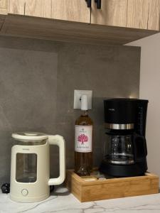a coffee maker and a coffeemaker on a kitchen counter at Avlή Apartments I in Kamári