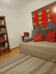 a living room with a couch with red pillows at Plantier Guesthouse in Figueira de Castelo Rodrigo