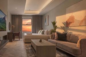a living room with a couch and a table at Stella Stays Olaya Tower 1 - Furnished Apartments in Riyadh