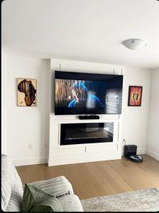 a living room with a large flat screen tv at La perle de Dieppe in Dieppe