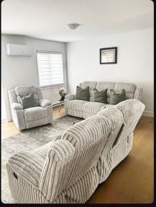 a living room with a couch and a chair at La perle de Dieppe in Dieppe +5 photos
