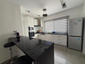 a kitchen with a black counter top in a room at Le Welcome Almadies in Ngor +5 photos