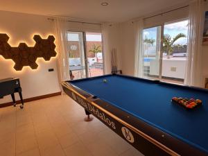 a pool table in a living room with a pool table at Villa Dedalos - Spacious luxury Villa with heated pool in Puerto Calero in Puerto Calero